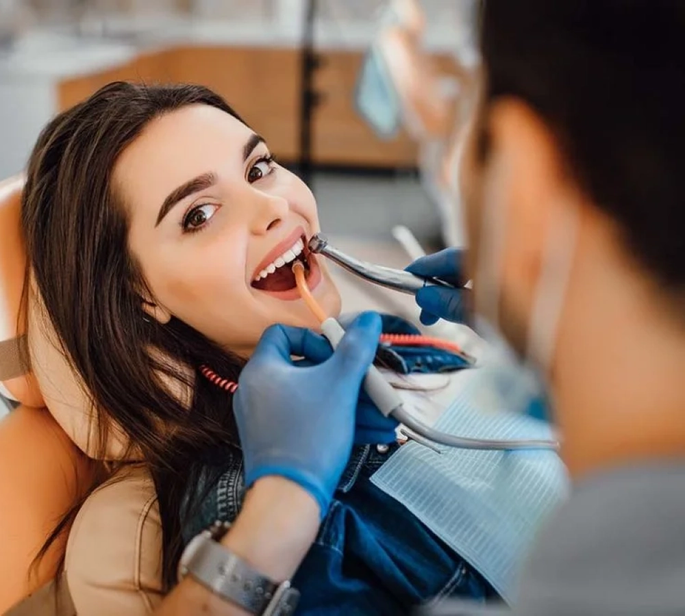 young-female-patient-visiting-dentist-office-1024x683.jpg